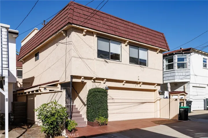 A rear view of the property with the staircase leading to the unit above the garage.
