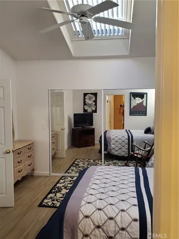 Main Bedroom with ceiling fan and sky light and walkin closest