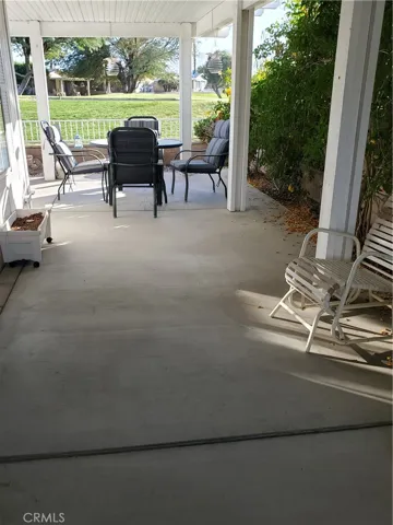view of side patio with table and chairs