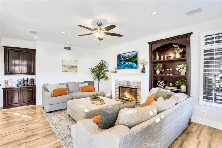 Relax and Enjoy this Elegant Family Room with Cozy Fireplace, recessed lighting and Custom Built-ins.