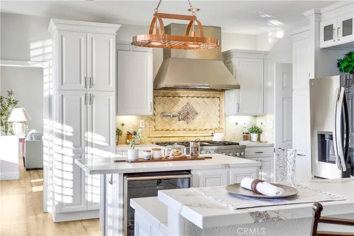Kitchen is fully equipped with Wine Refrigerator, Warming Bin, Microwave, multiple pullout drawers with soft close hinges, pot hanger with built in light over Island and brand new, designer slab counter tops.