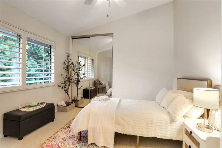 Another Good Sized Bedroom with High Ceilings, Mirrored Wardrobes, Plantation Shutters and a Ceiling Fan.