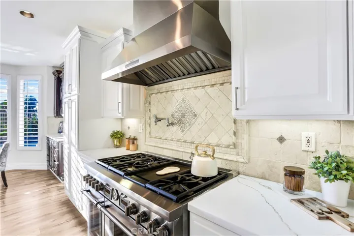 Newer Thermador six burner, gas stove top with grill, double oven, pot filler and SS Hood.