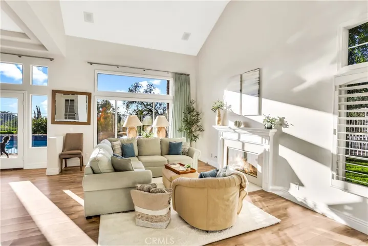 Upon Entering this house you will be greeted by this well lit Living Room, Light and Bright with super high ceilings, double window and romantic fireplace.