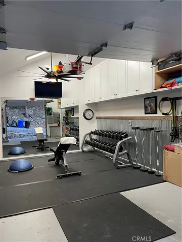 Garage interior.  Completely finished room currently used as home gym    Custom cabinetry, cathedral ceilings, completely dry walled and still has operable garage door with auto opener