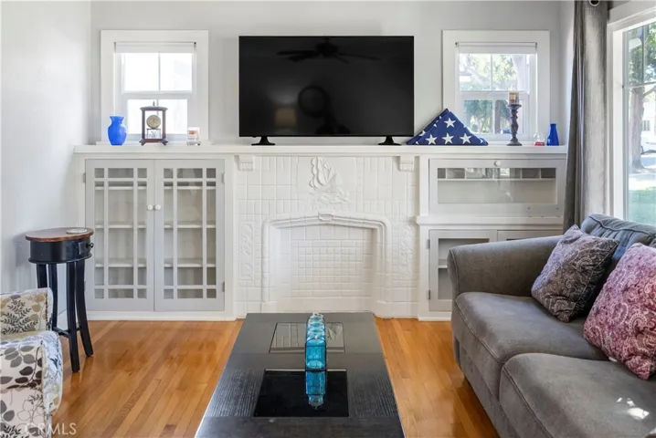 Decorative fireplace flanked by built-ins.