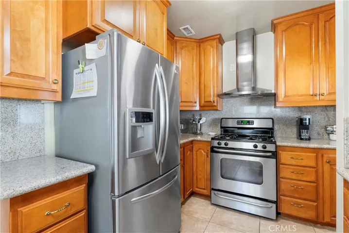 Gas stove, built-in lazy susans, granite counters, and refrigerator stays!