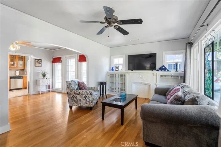 View of living room from front door with curved entry into the formal dining room.