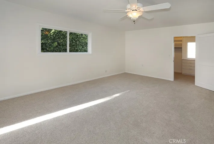Primary bedroom - spacious walk-in closet through doorway in the back