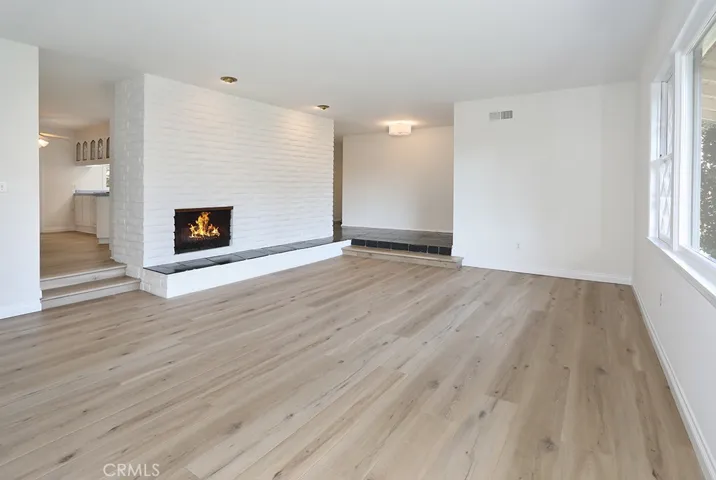 Alternate view of living room toward front entry and breakfast nook to the left