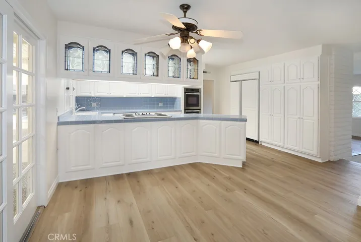 view of breakfast nook and kitchen from game/bonus room entrance