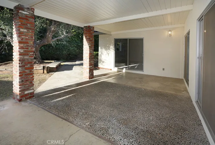 Back patio accessible through the game room, breakfast nook, dining room, 5th bedroom/primary retreat/office and primary bedroom