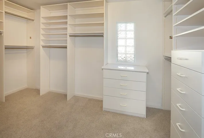 Primary bedroom walk-in closet