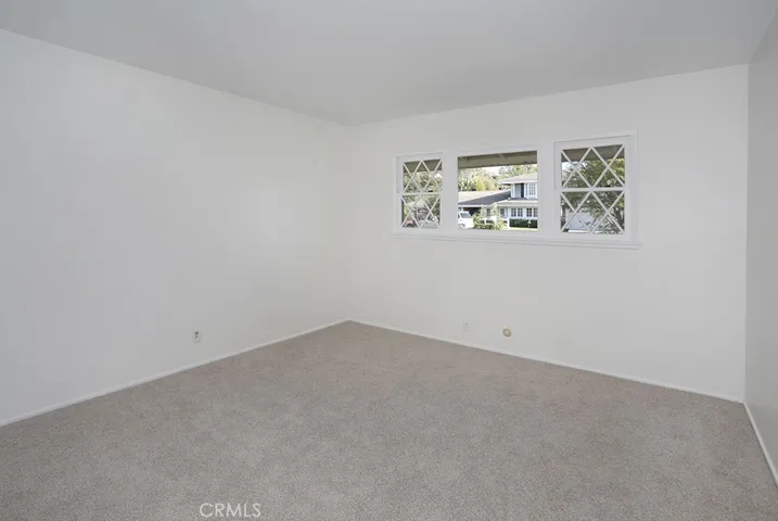 Guest bedroom 4 at end of hallway overlooking front yard