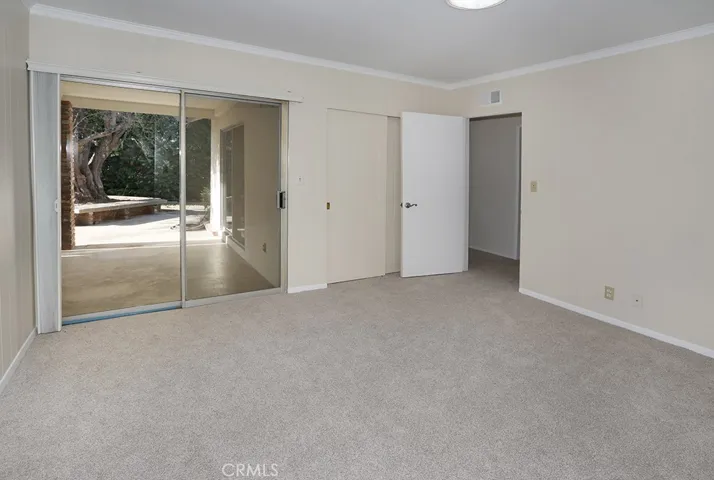 Guest bedroom 1/office/den off primary suite - access to back patio