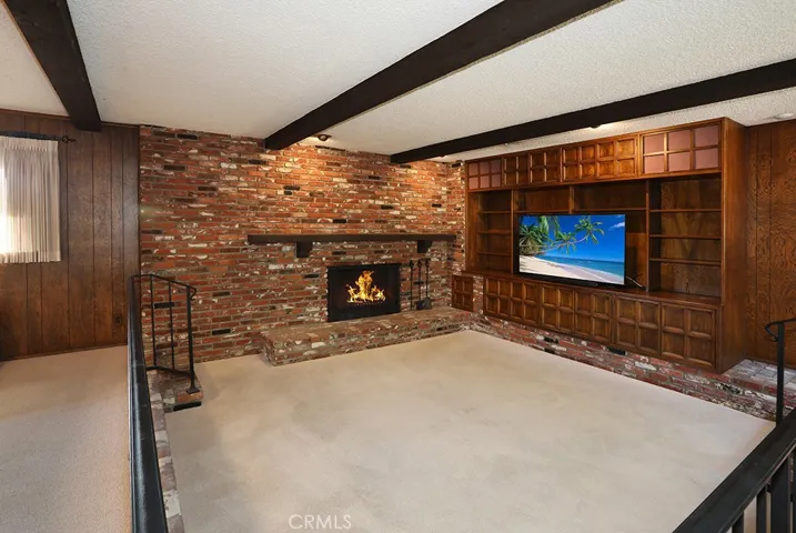 Step down seating area with cozy fireplace
