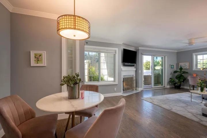 The dining area is a cozy space w/ beautiful light fixtures
