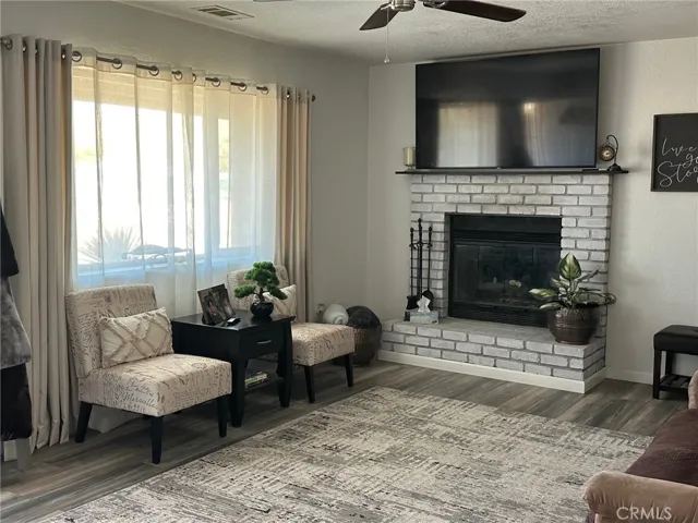 Living room with whitewash fireplace