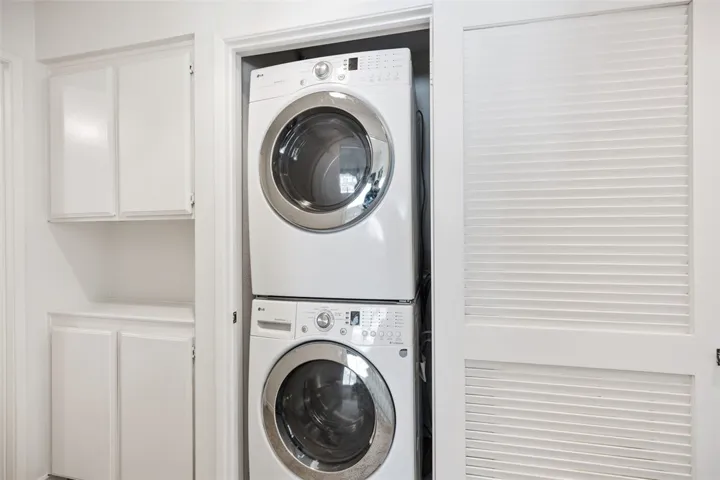 Stackable Washer and Dryer in Closet in Hallway  Included with Sale of Property