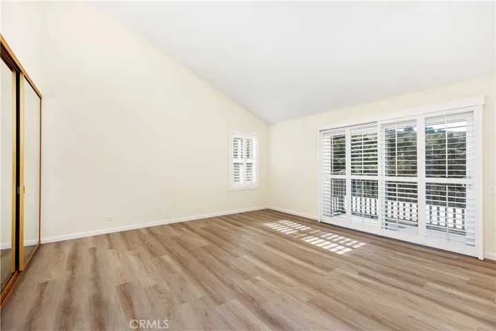 Primary bedroom with plenty of space and vaulted ceilings. So much natural light!