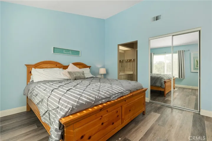 Large primary bedroom with a standard closet as well as a walk in closet.