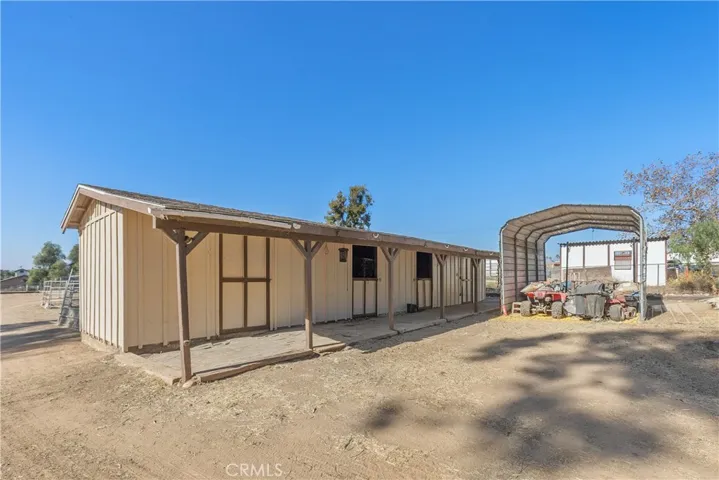 Wood barn with two stalls, tack room, and feed room