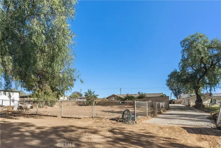 Below the pool area is a fully fenced in yard