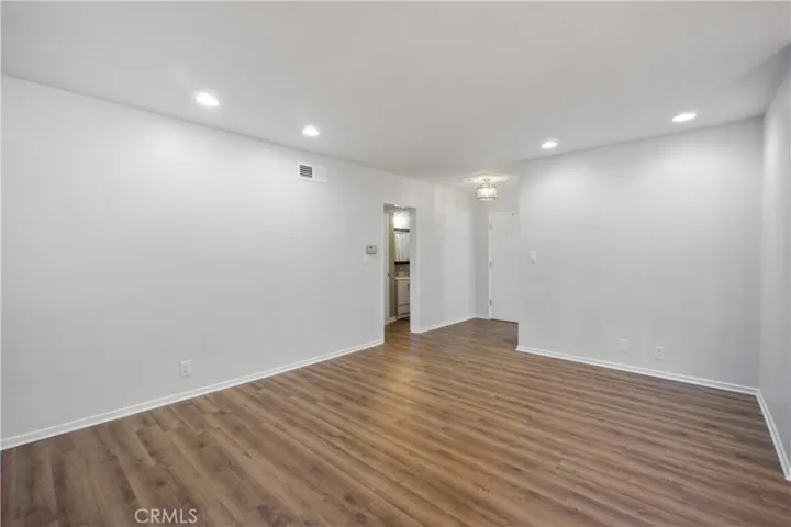 View of the living room towards the hallway and entryway. Entryway light fixture is new.
