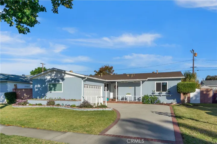 Front of home. A variety of plants/flowers were recently added. Garage door is automatic and was installed in 2022. Gate to the right leads into the backyard area.
