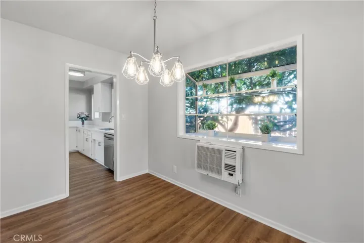Another view from the living/dining room area into the kitchen. Bay window is perfect for plants, flowers or any decorative items.