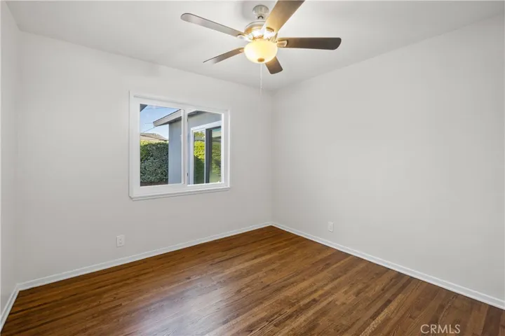1st bedroom across from the 3/4 bath. Hardwood floors were refinished. Walls were freshly painted. Ceiling fan and double pane windows are new. Window faces the backyard patio area.