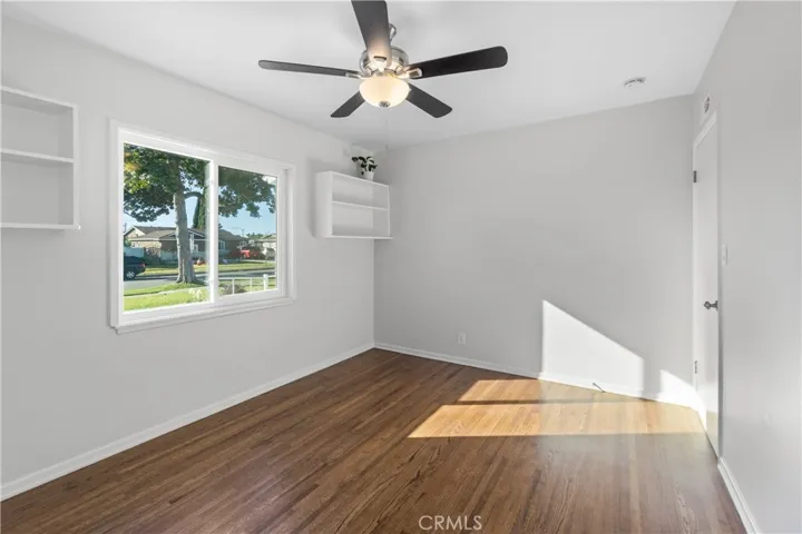 2nd bedroom faces the front yard/driveway. Walls were freshly painted. Hardwood floors refinished. Ceiling fan is new. Shelves provide added space to store or showcase important items. Closet is similar to the 1st bedroom with bi-fold doors, but has shelving inside to provide added storage. Double pane windows are new.
