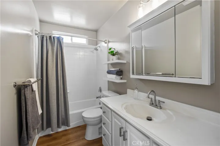Full bath is down the hall. It's back to back to the 3/4 bath. Cabinets were refinished. Shelves and brush nickel faucet are new as well as the water efficient toilet. Light fixture above mirror is new. Bathroom was freshly painted. New vinyl planks were installed.