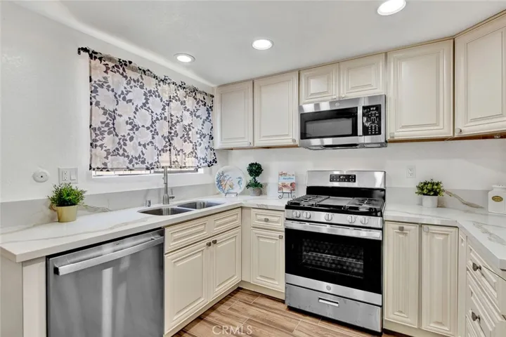 New kitchen cabinets and appliances lighting and ceiling fan.  gas stove.
