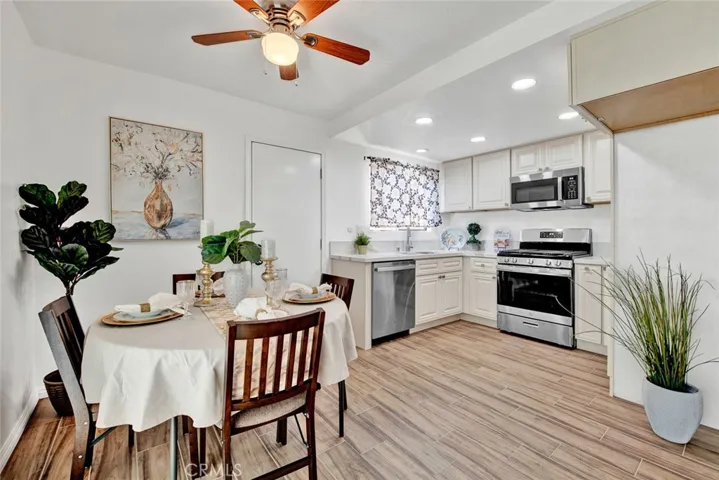 New kitchen cabinets and appliances lighting and ceiling fan.  gas stove. door to back patio.