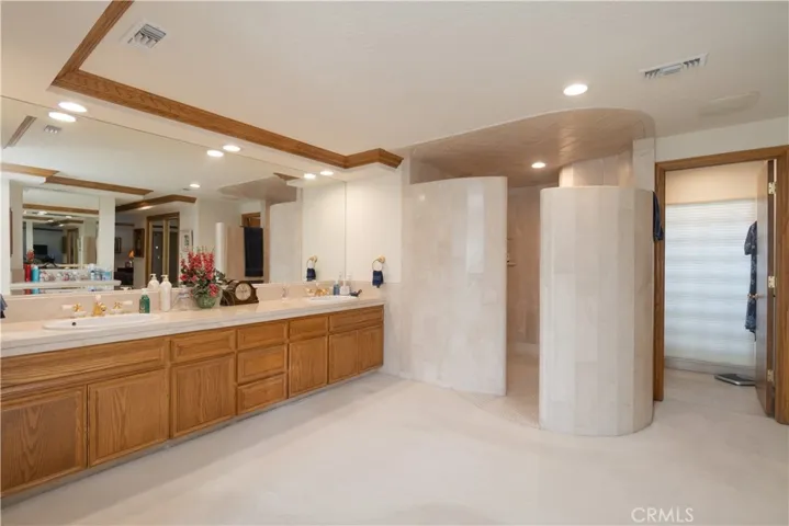 Primary bedroom double sink with walk in shower