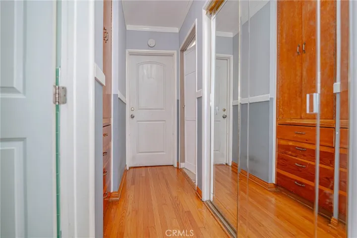 Hallway w/ closet and built in drawers/cabinet