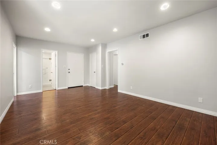 Front door entry to expansive family room, hallway bath, and kitchen entry
