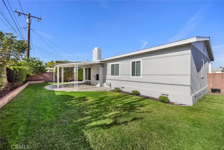 Large backyard patio and grass area for entertaining