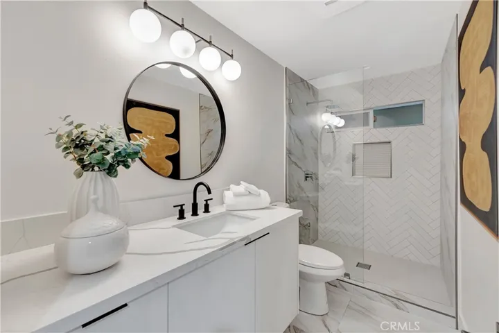 Hall Bath Features Walk Around Shower, Floating Cabinetry And Quartz Counters