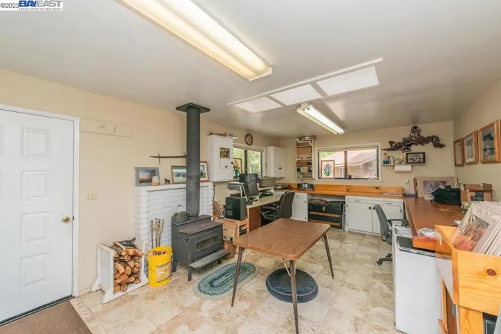 Laundry room / bonus room with wood stove.