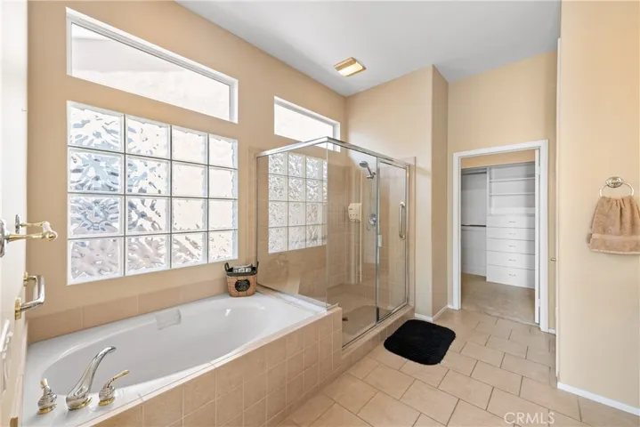 Master bathroom suite. Separate shower and tub. Walk-in closet. Glass block windows for generous light.