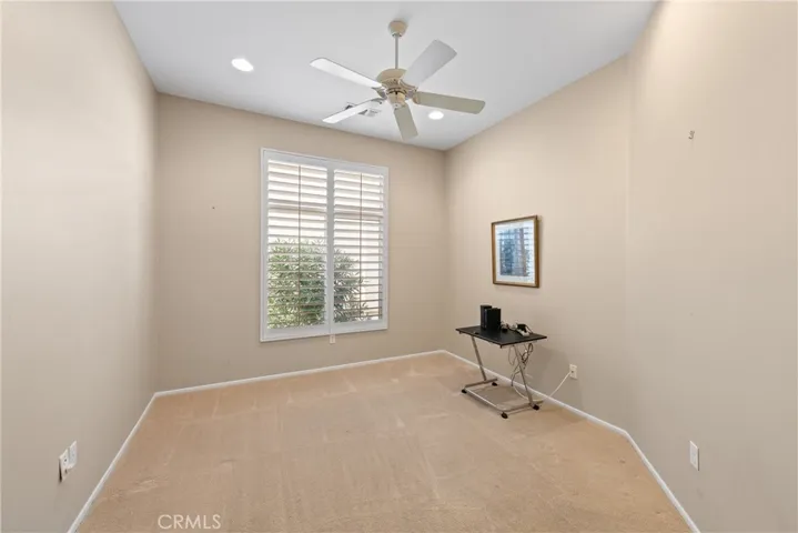 Den/study/office.  Plantation shutters. Ceiling fan.