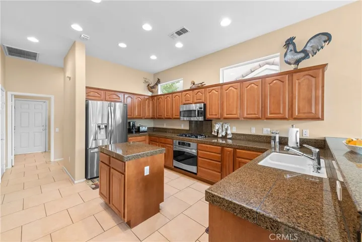 Stainless steel appliances. Storage pantry.
