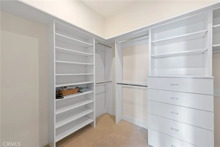 Large oversized walk-in closet with custom built-ins.