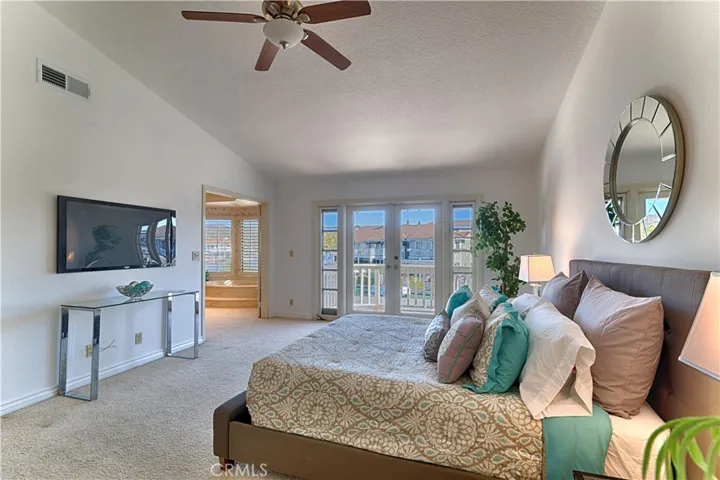 primary bedroom with doors to balcony