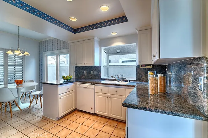kitchen with granite countertops white cabinets