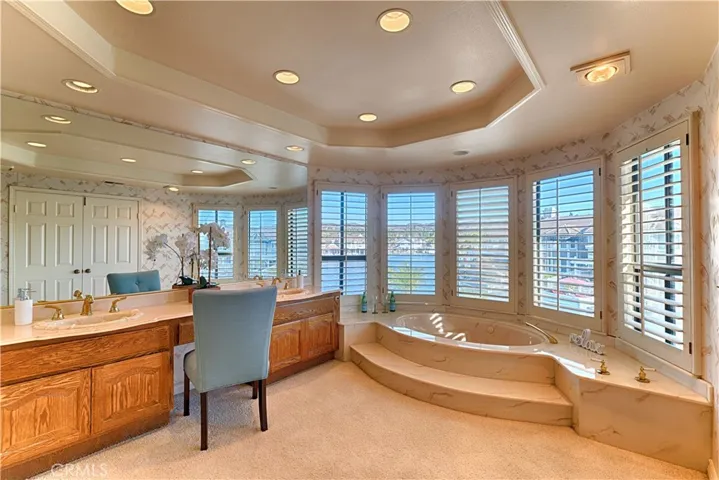 primary bath with tub and dual sinks