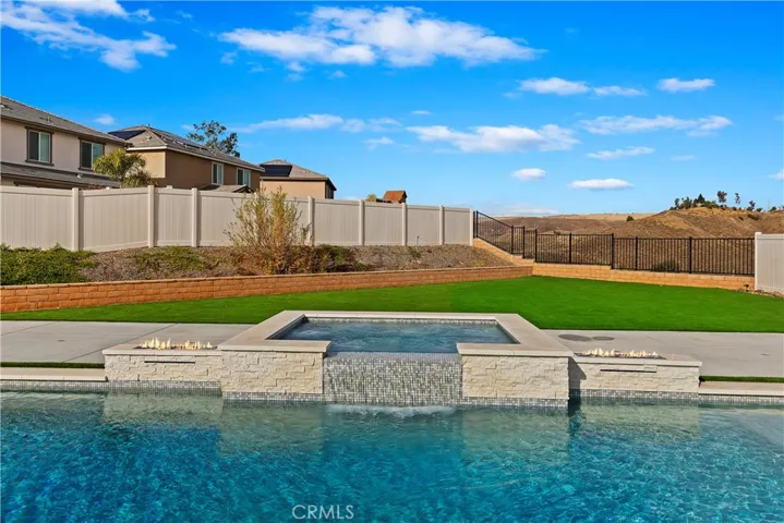Pool has fire features and three water falls