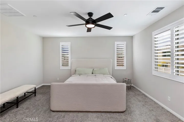 Spacious master bedroom with shuttered windows